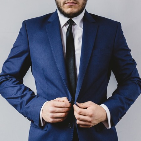 A man in a suit displaying chivalry