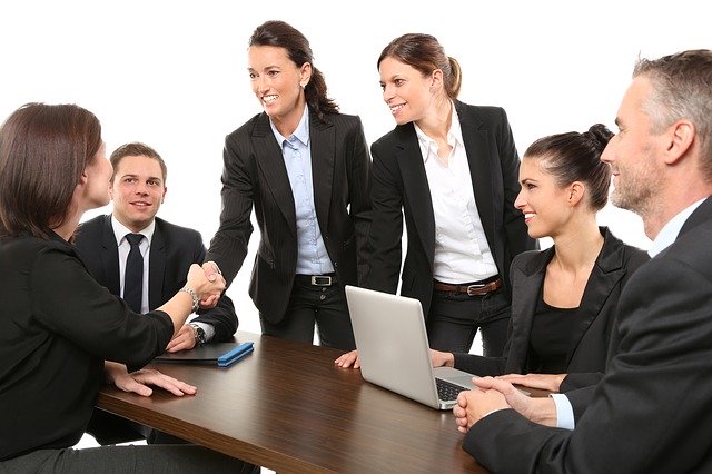 Business people having a meeting with two shaking hands